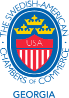 Logo of the Swedish-American Chambers of Commerce Georgia featuring a crowned red and white shield with “USA” text, surrounded by blue and the organizations name in a circular layout.