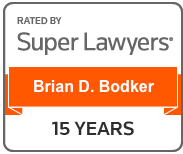 A badge reading Rated by Super Lawyers, Brian D. Bodker, 15 Years in black and orange text.