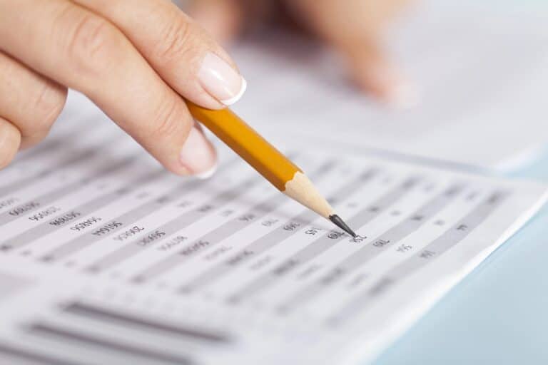 A hand checks part of a financial document