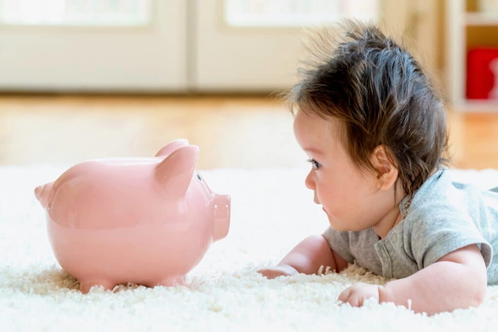 Baby boy with a piggy bank